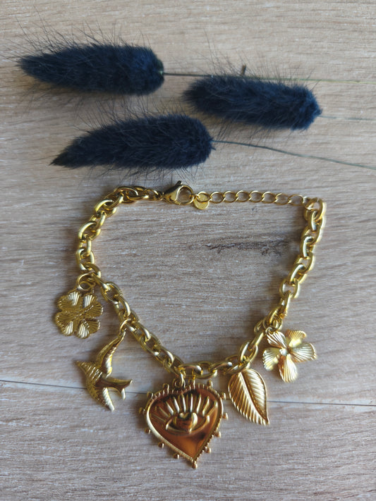 bracelet en acier inoxydable de couleur doré avec motifs représentant la chance et le bonheur